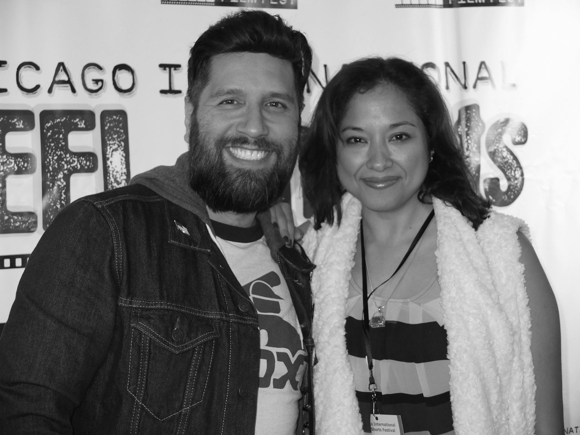 Man with beard and woman smiling at the Chicago Film Festival; man in denim jacket, woman in white shawl.
