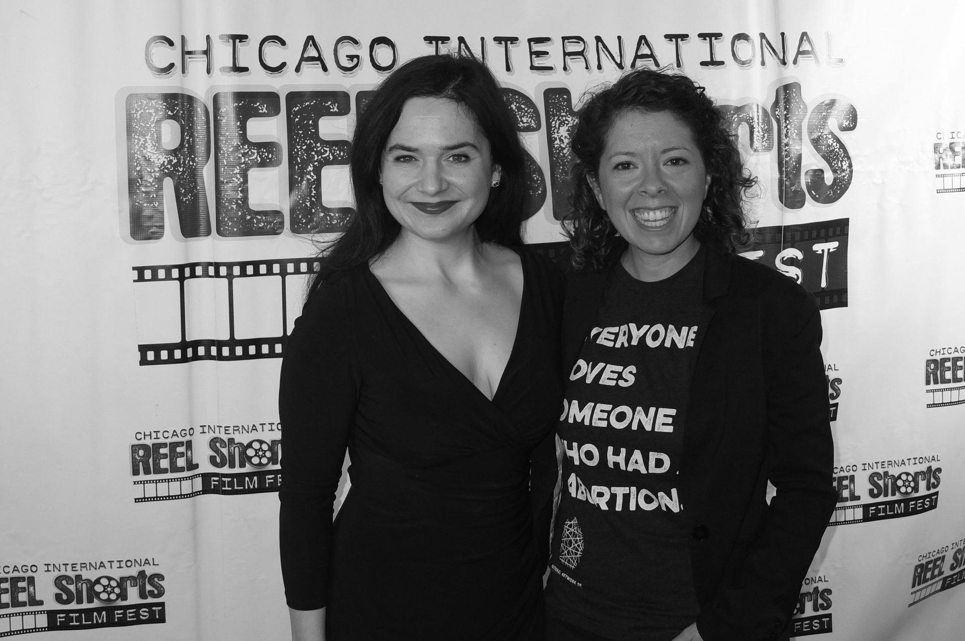 Two women at a film festival, one wearing a shirt that says 