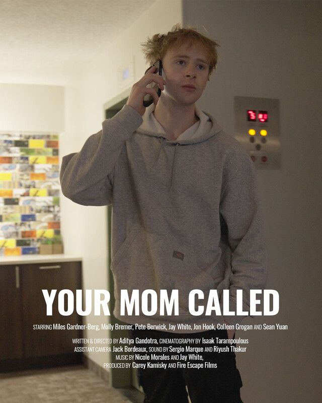 Young man in a grey hoodie on the phone, elevator and counter in background. Movie poster for 