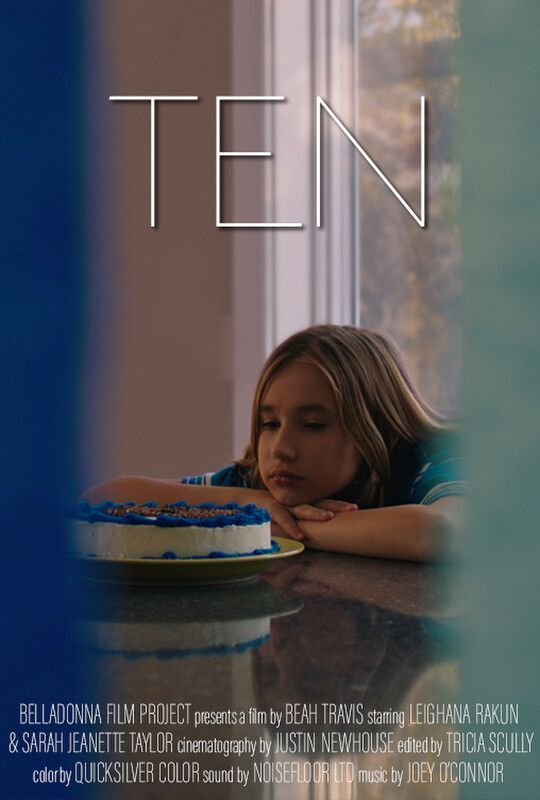 A young girl with a sad expression sits near a birthday cake by a window; the movie poster title is 