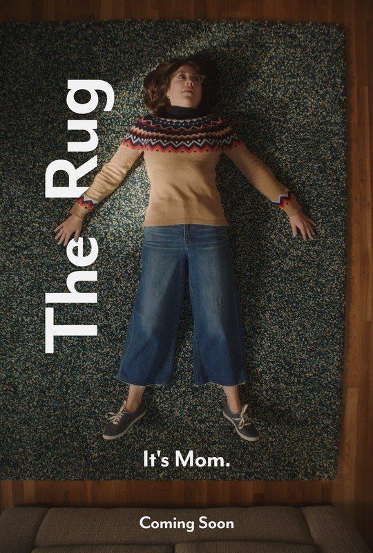 A movie poster for the rug shows a woman laying on a rug.