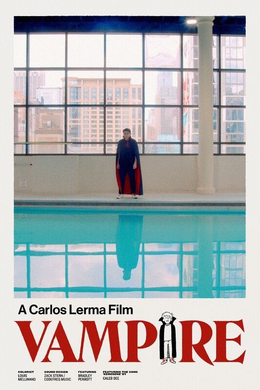 A person in a cape stands near a pool, reflected in the water. A city is seen through a window.