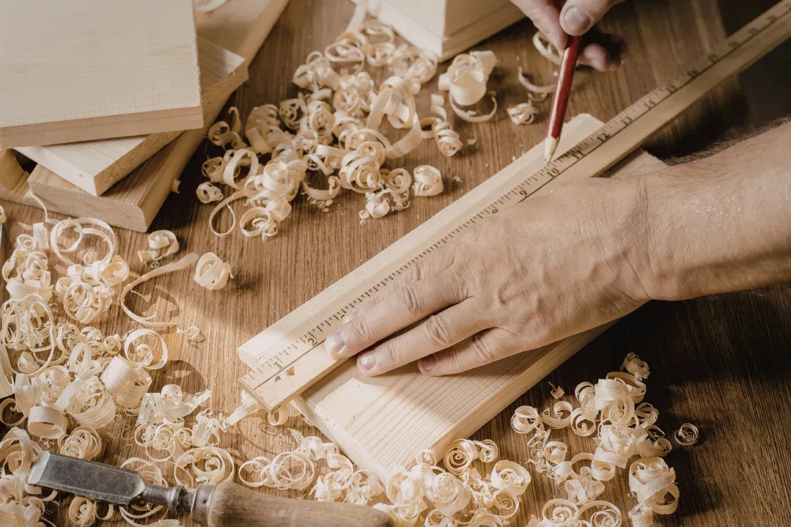 White fireplace with black countertop and built-in shelving, TV, and cabinets against white wall. Blue rug on floor.