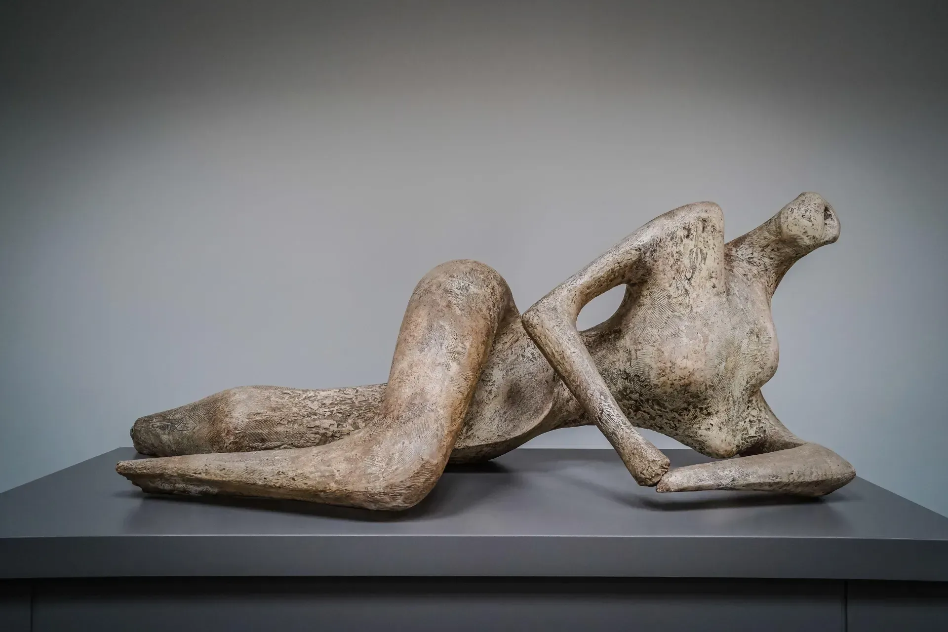 Quastel Associates | A statue of a woman laying down on a table.