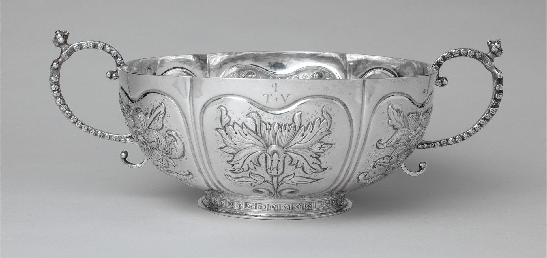 Quastel Associates | Silver bowl with ornate handles and etched floral design. 