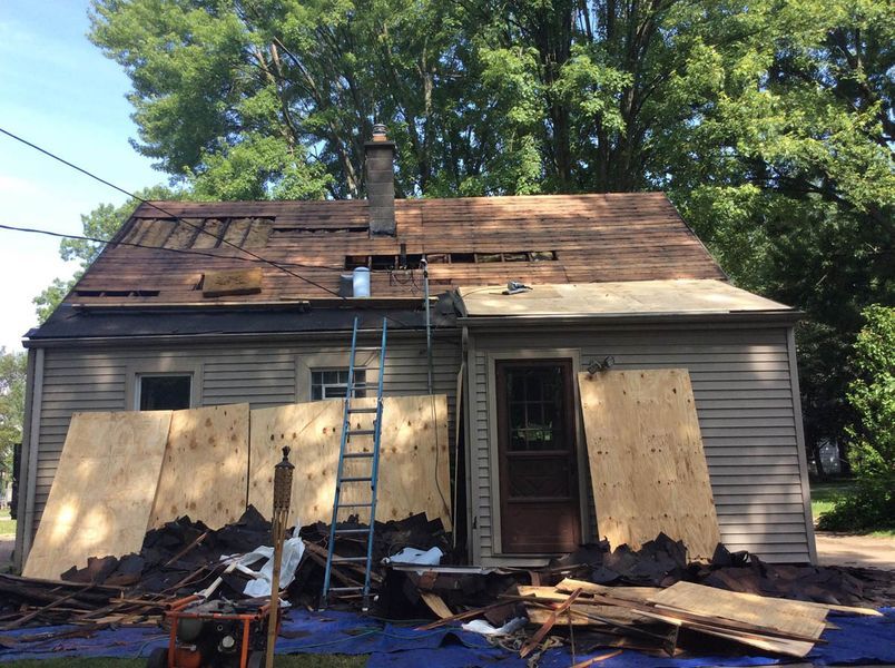 a house with a ladder and debris.