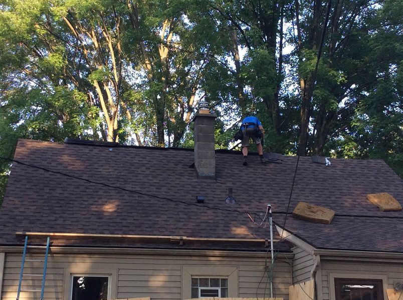 a man standing on a roof.
