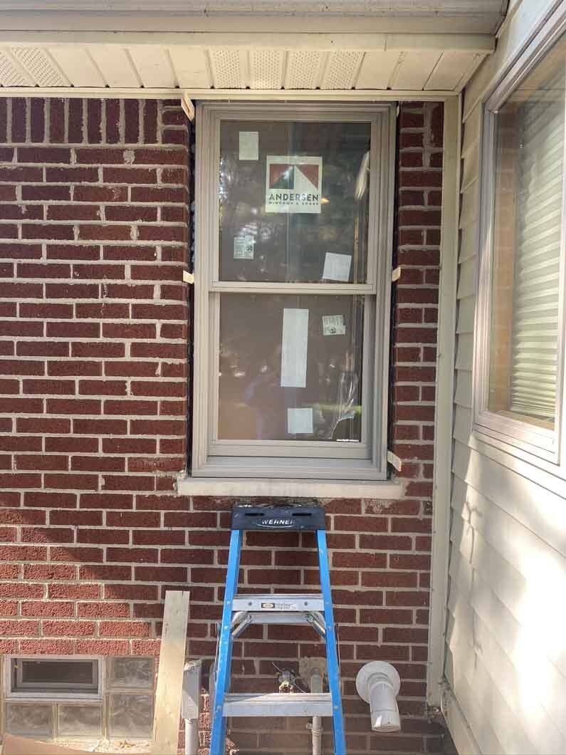 a ladder next to a window.