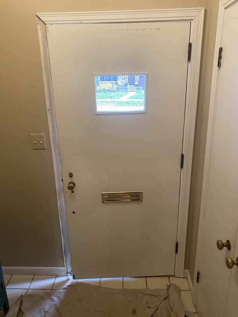 a white door with a square window.