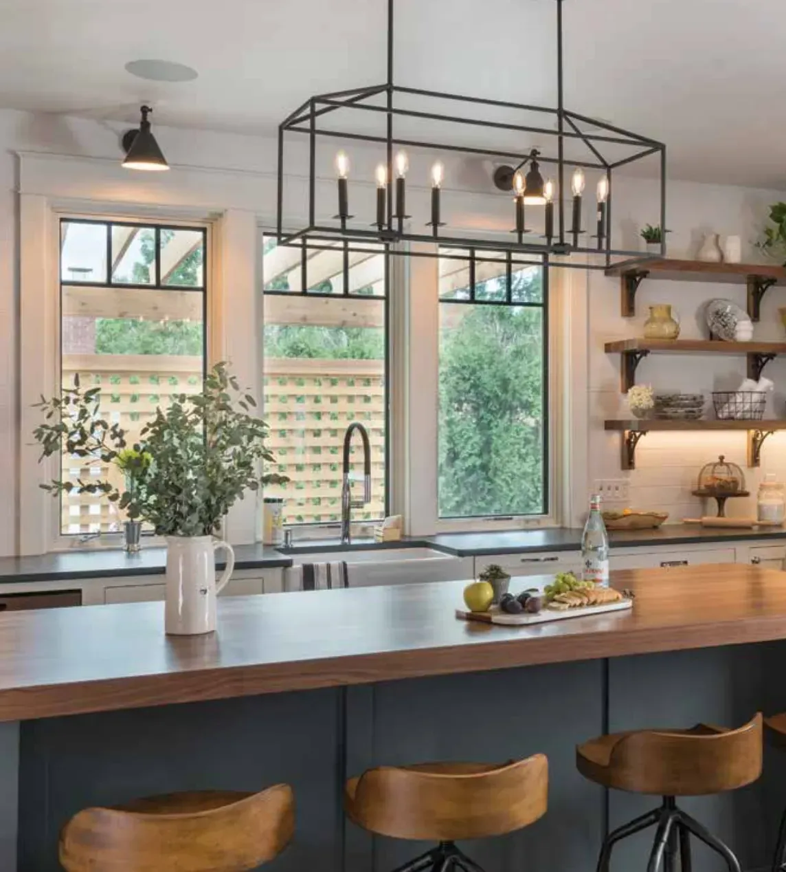 A cozy kitchen with warm lighting, wooden cabinets, and a rustic farmhouse table.