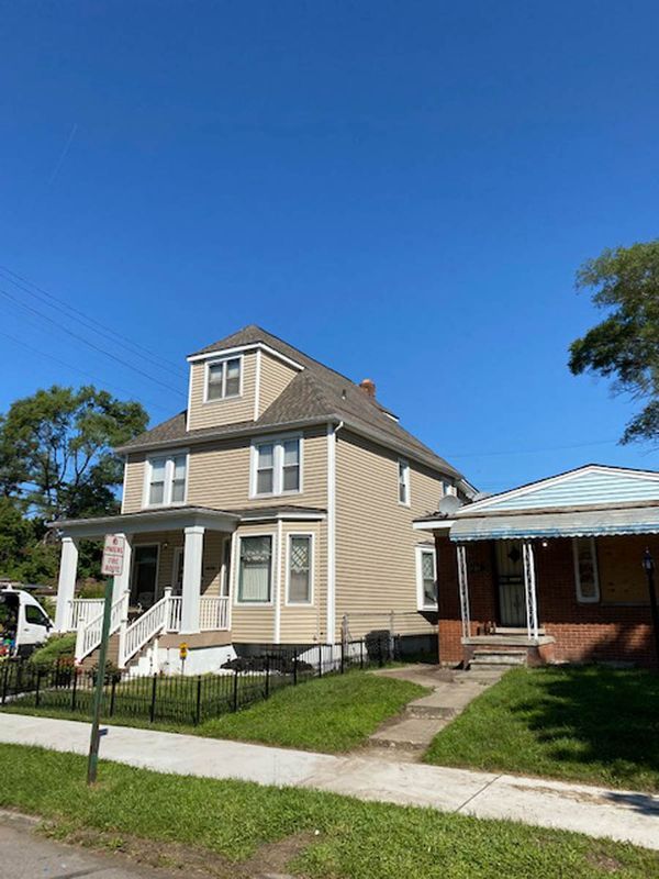 a house with a fence and a sidewalk