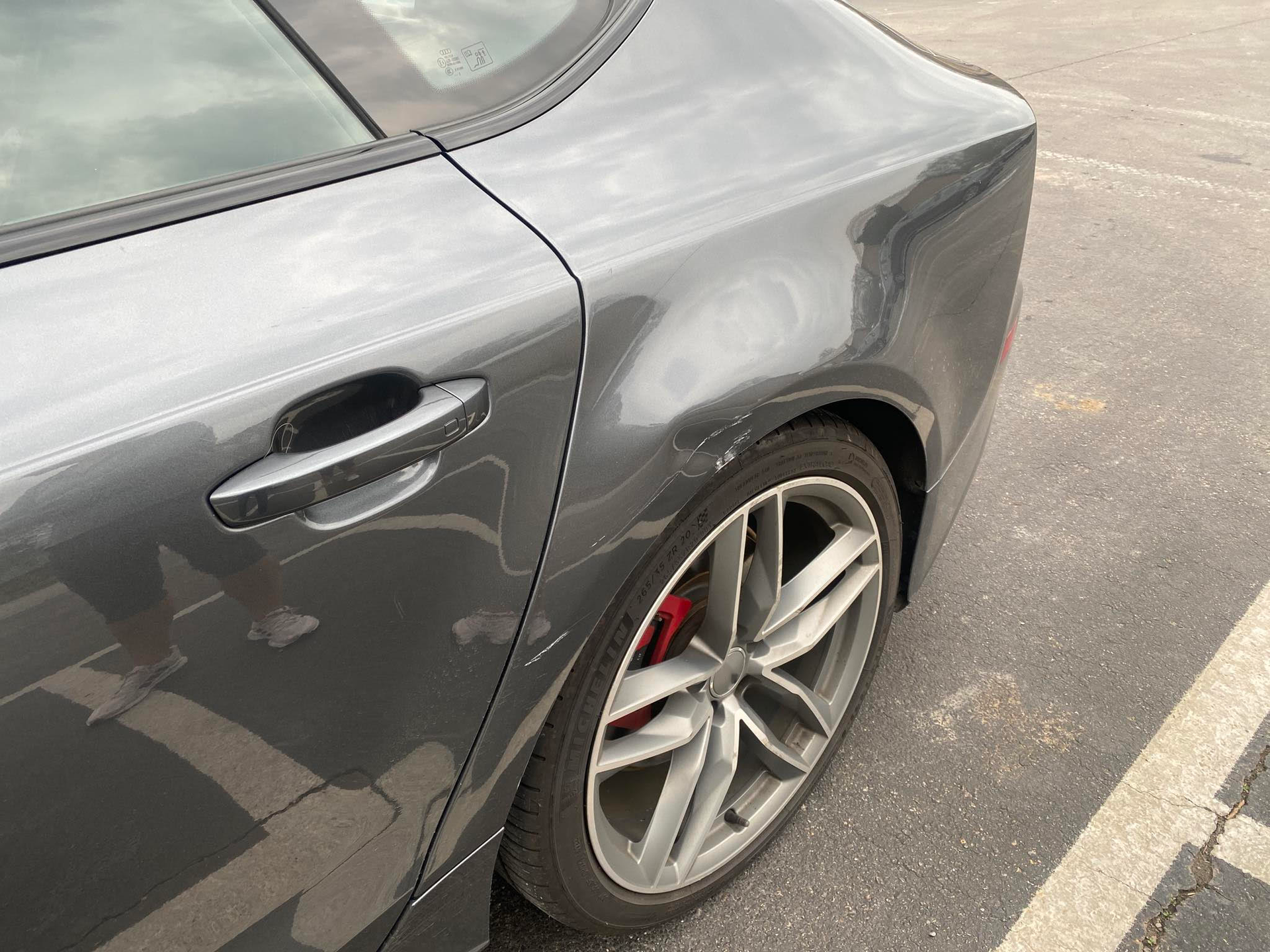 A gray car is parked in a parking lot.  | Windham Bodyshop