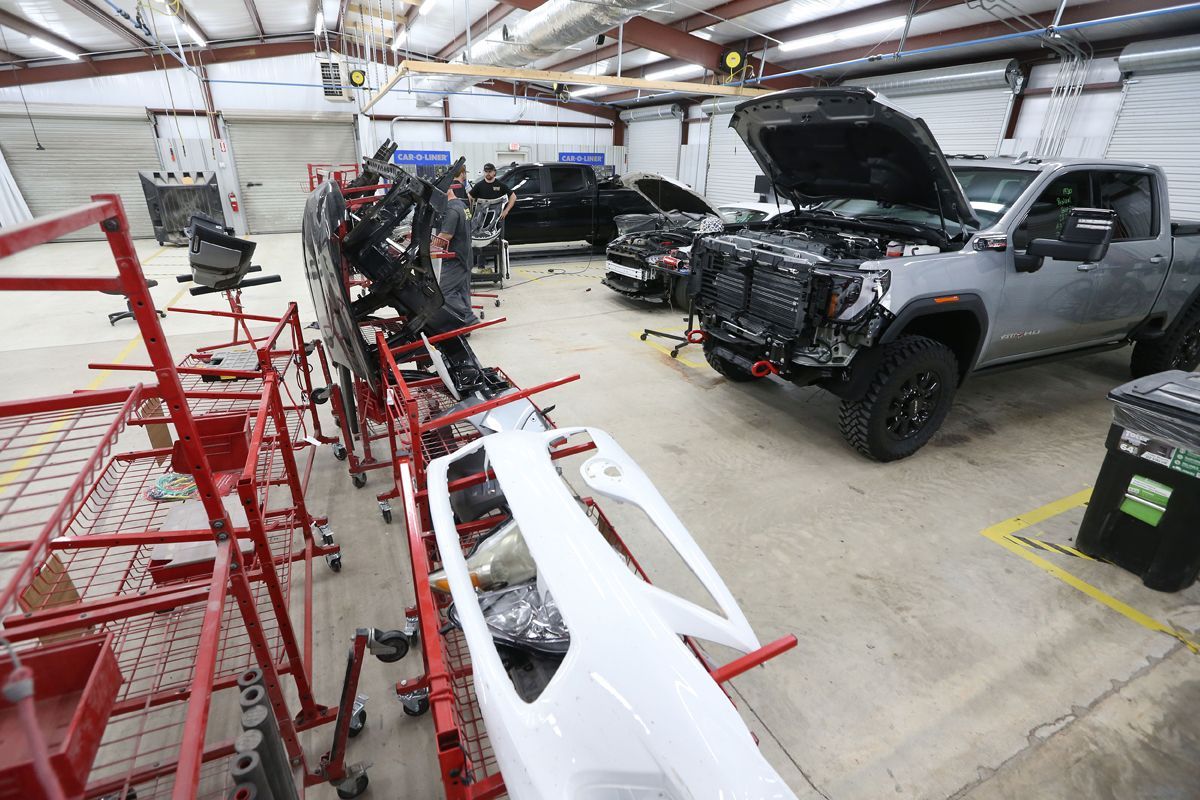 Inside of our garage with various vehicles | Windham Bodyshop