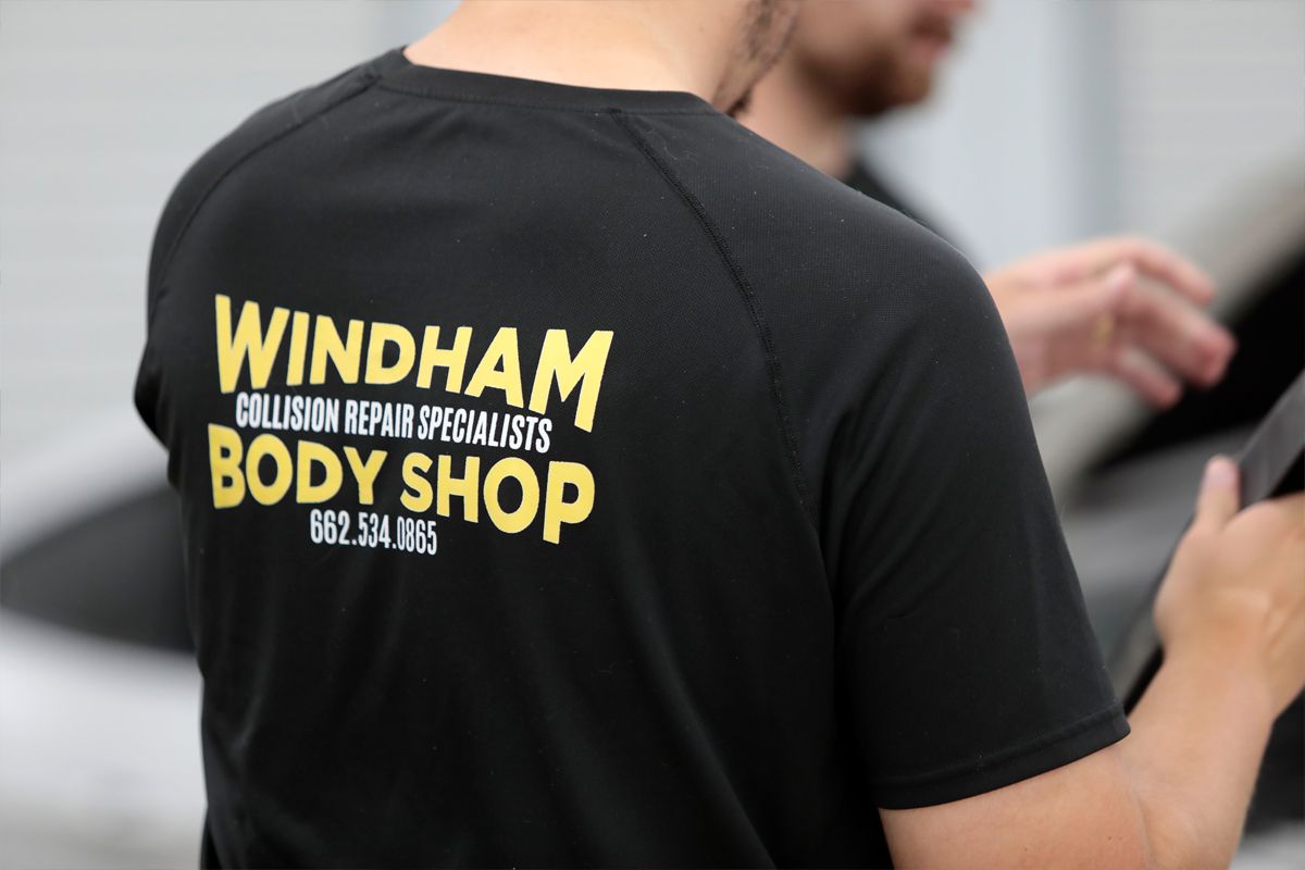 Back view of our staff wearing a black shirt with our logo | Windham Bodyshop