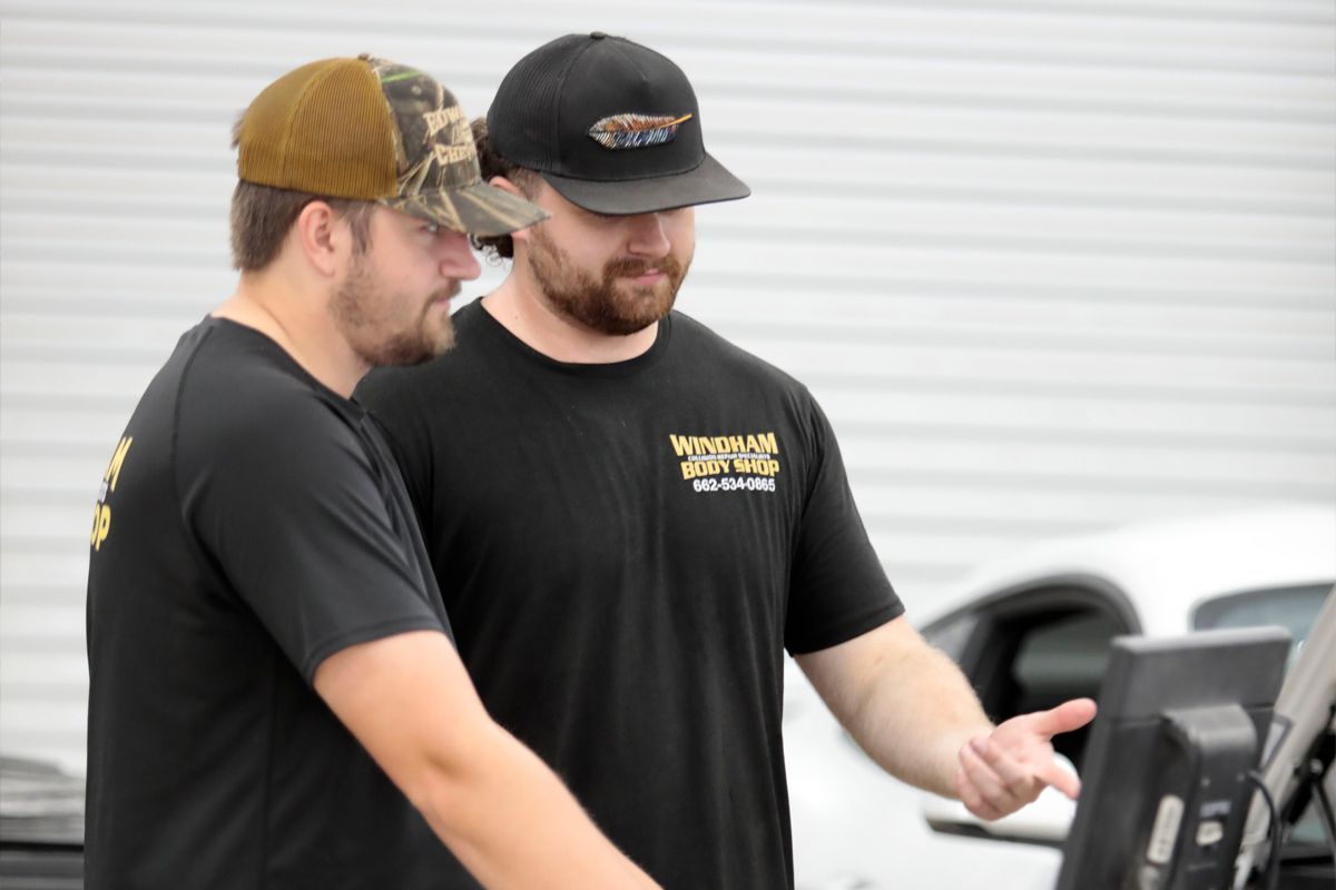 Two mechanics discussing diagnostics in our garage | Windham Bodyshop