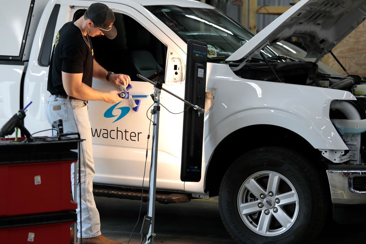 Our expert staff performing detailing on a white truck | Windham Bodyshop