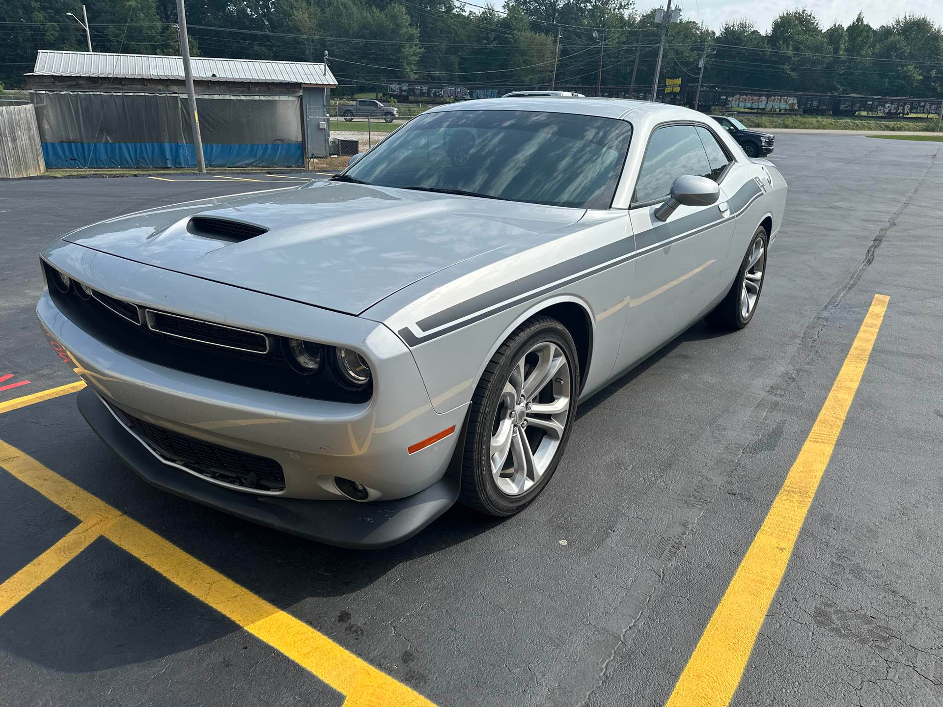 A silver dodge challenger is parked in a parking lot.  | Windham Bodyshop