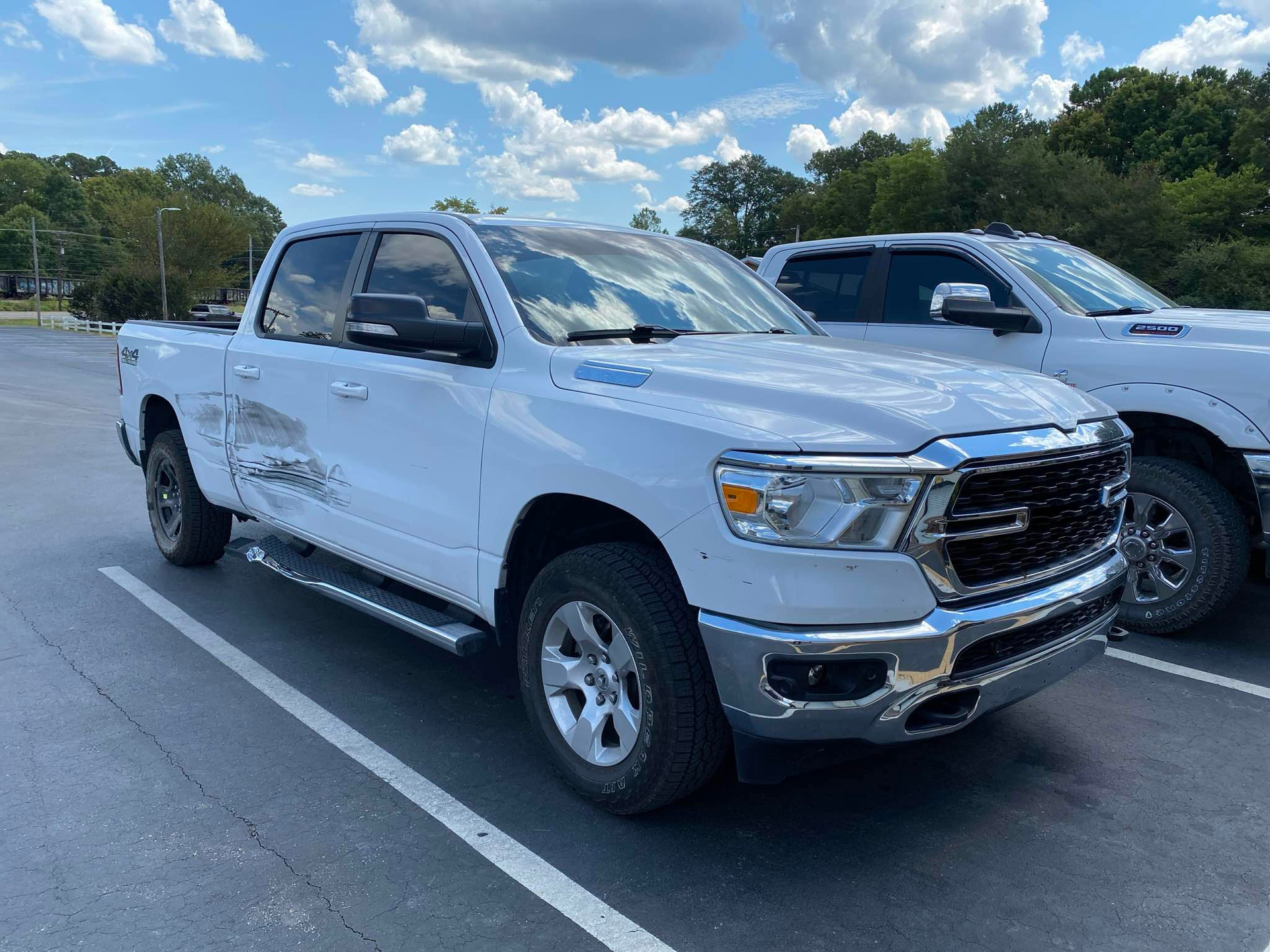 Two white trucks are parked in a parking lot.  | Windham Bodyshop