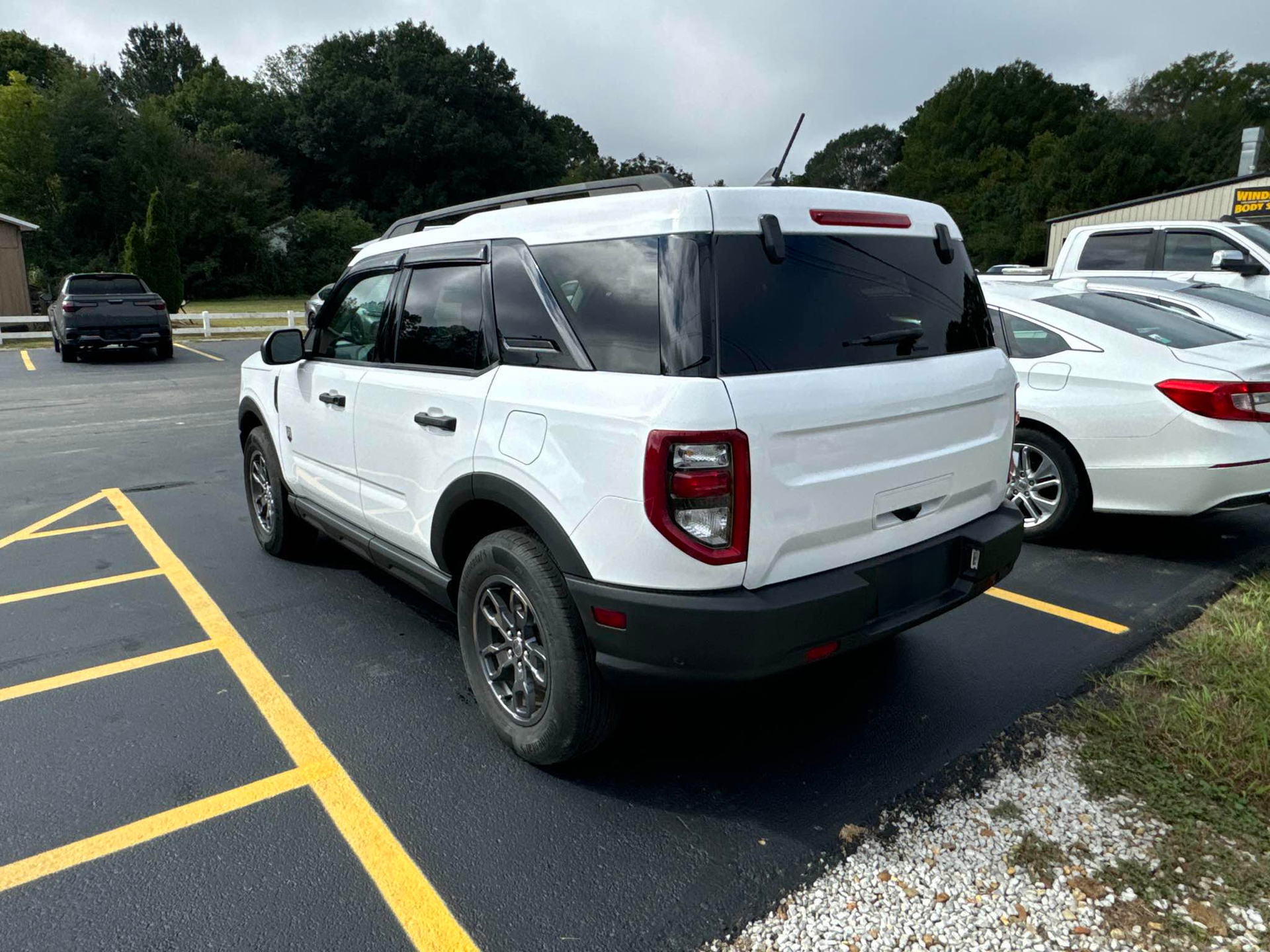 A white ford bronco sport is parked in a parking lot.  | Windham Bodyshop