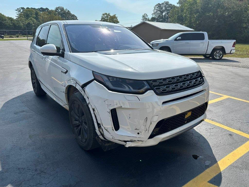 A white land rover discovery is parked in a parking lot.  | Windham Bodyshop
