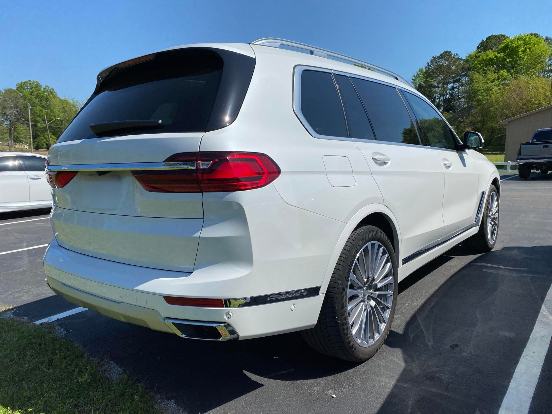 A white bmw x7 is parked in a parking lot.  | Windham Bodyshop