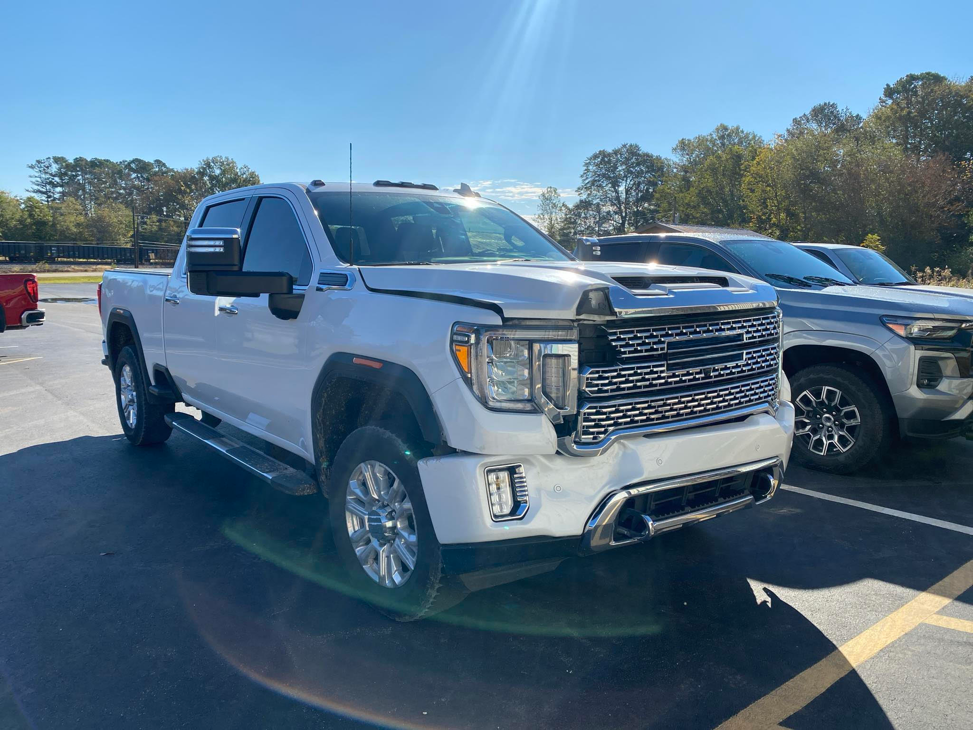 A white pickup truck is parked in a parking lot.  | Windham Bodyshop