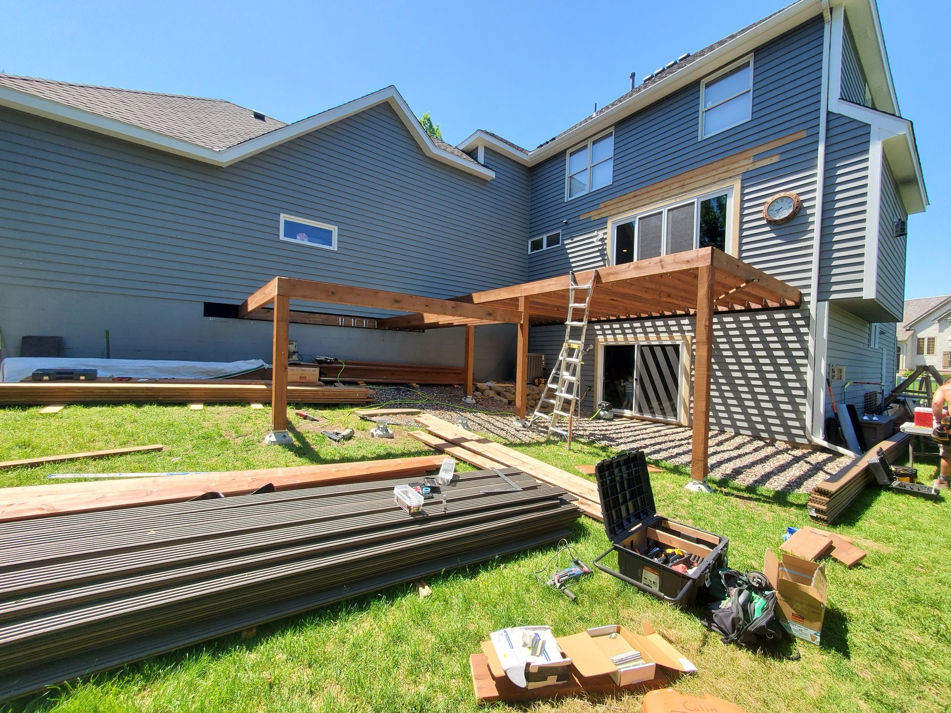 A house with a pergola being built in the backyard.