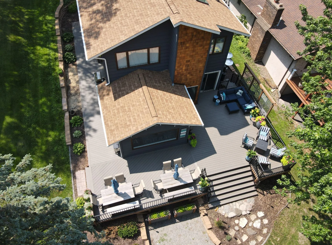 An aerial view of a house with a large deck and patio.