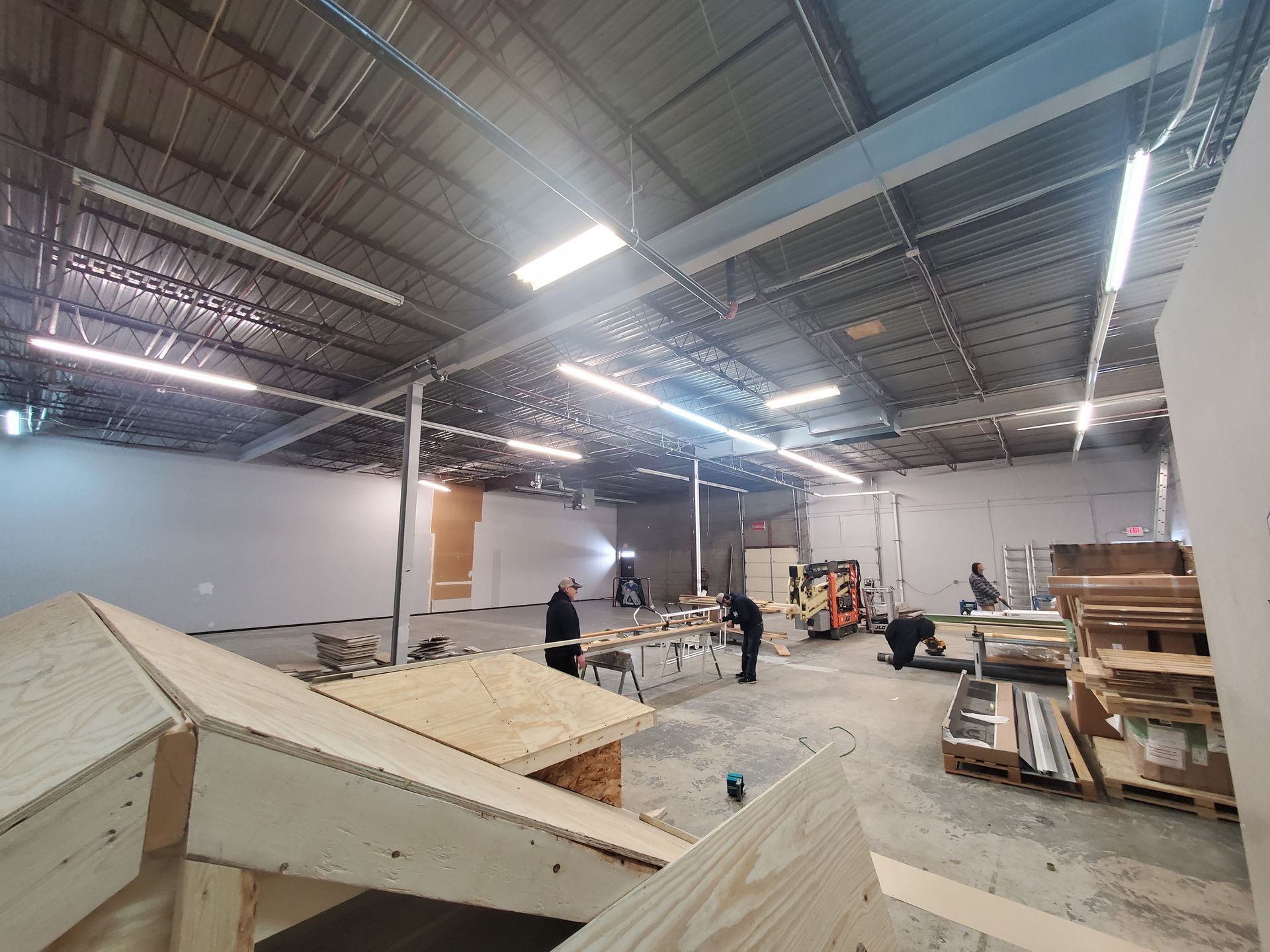 A group of people are working in a large warehouse.