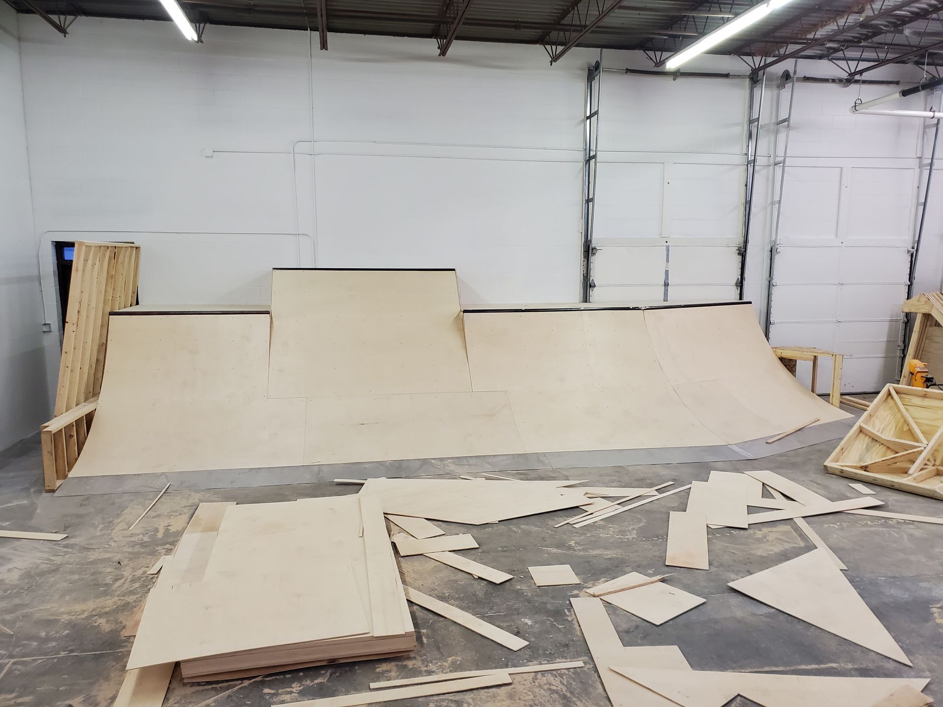 A wooden ramp is being built in a garage.