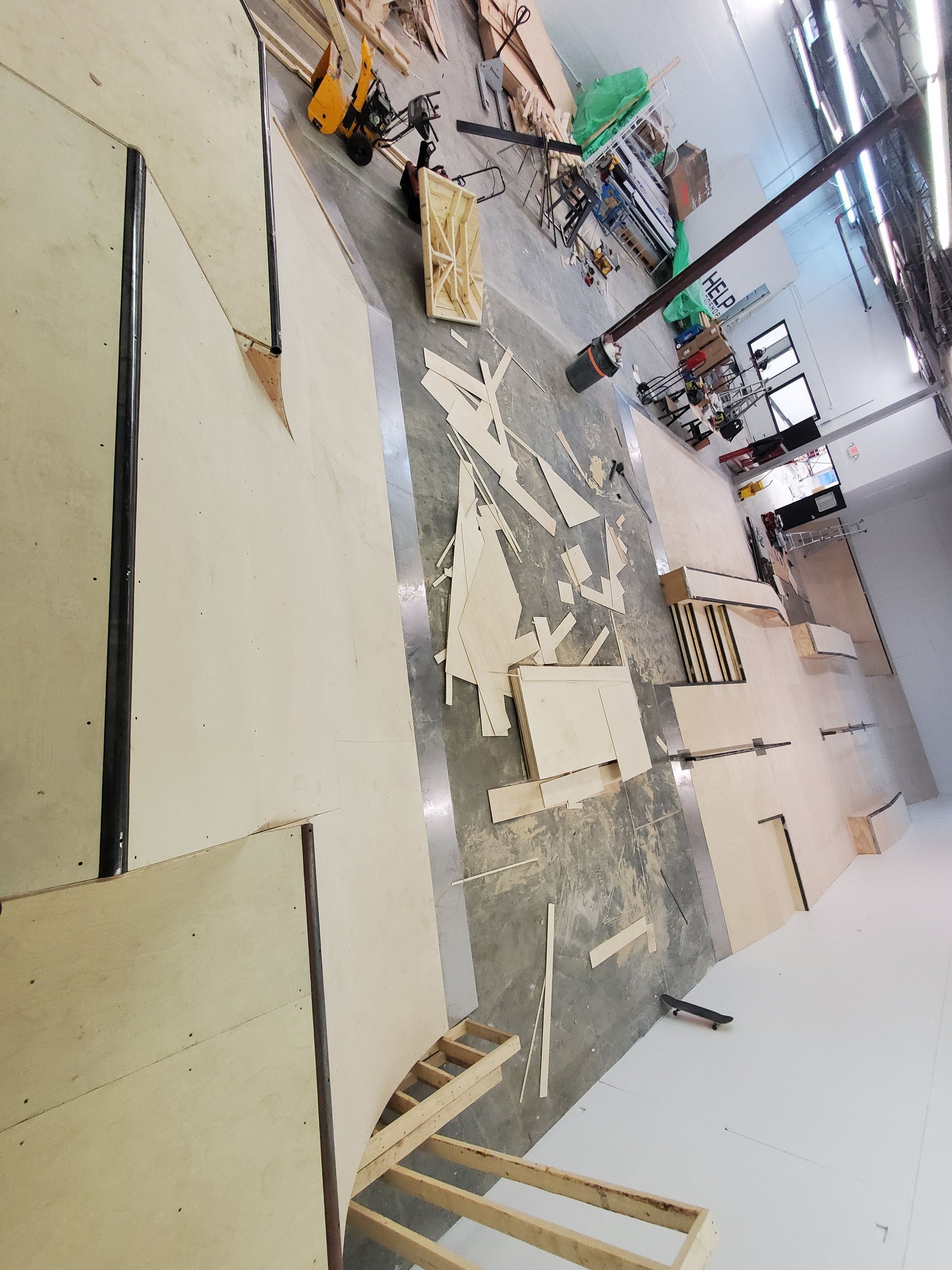 A large room with a lot of wood on the floor.