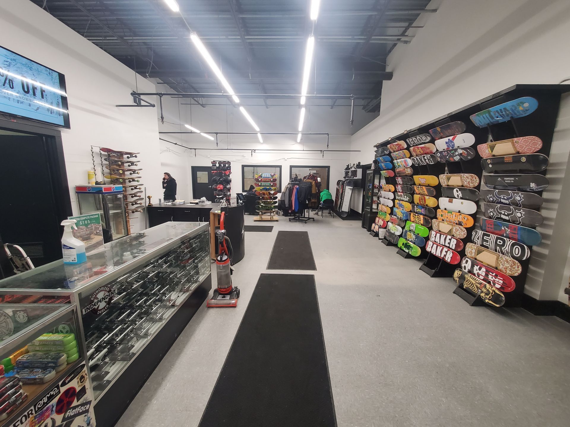A store filled with lots of skateboards and sunglasses.
