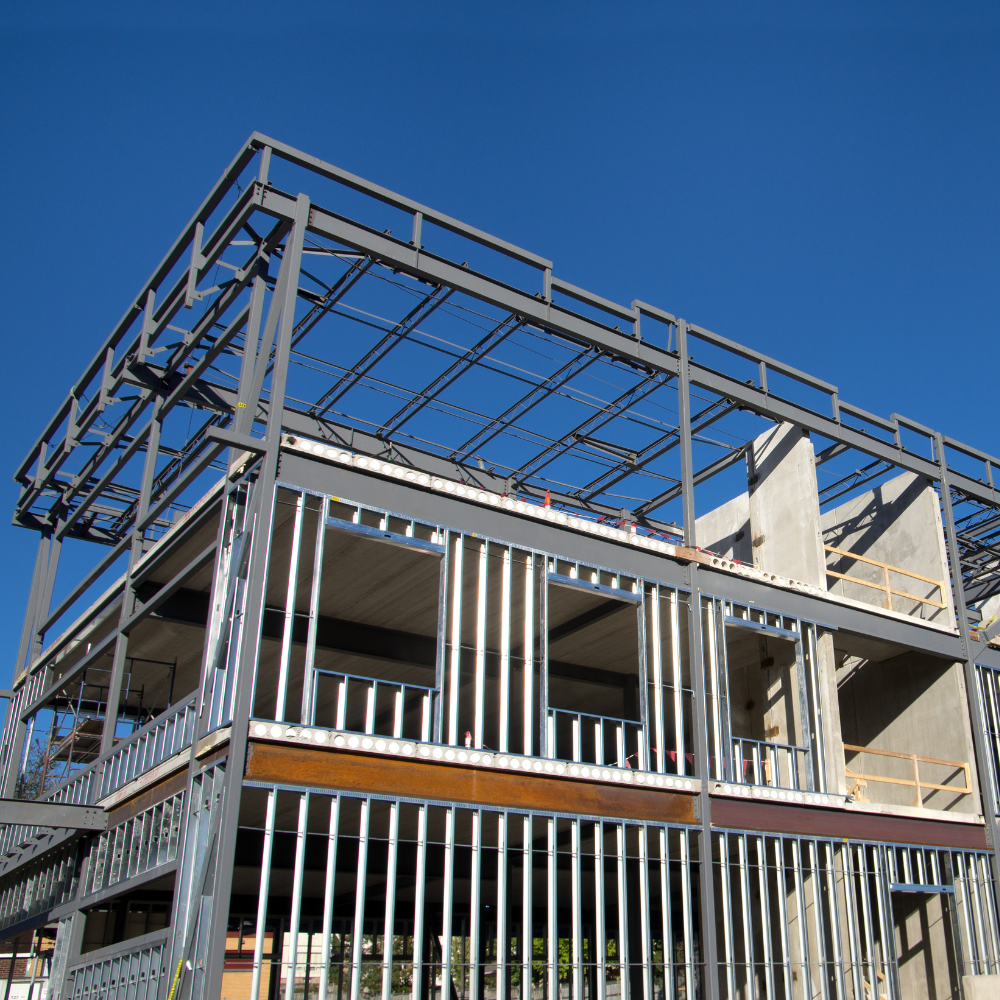 A building under construction with a blue sky in the background.