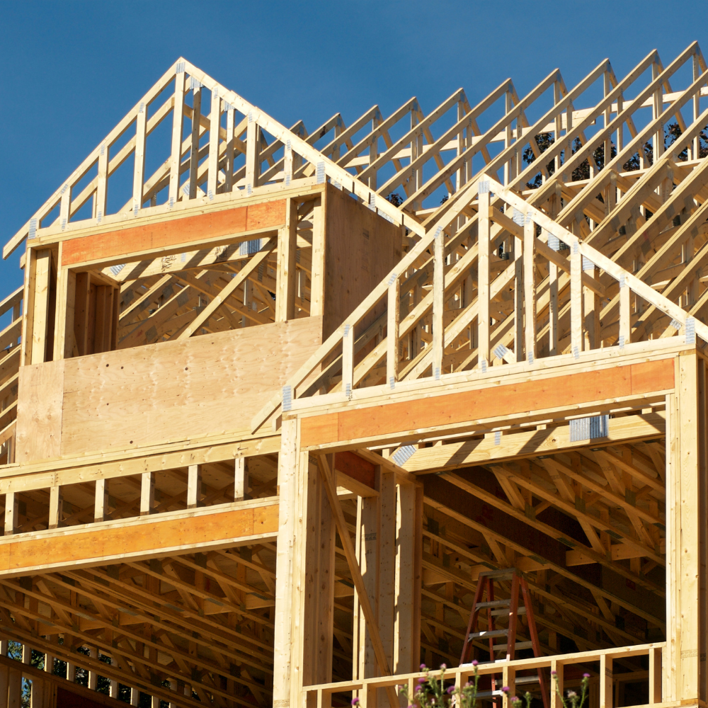 A house under construction with a blue sky in the background