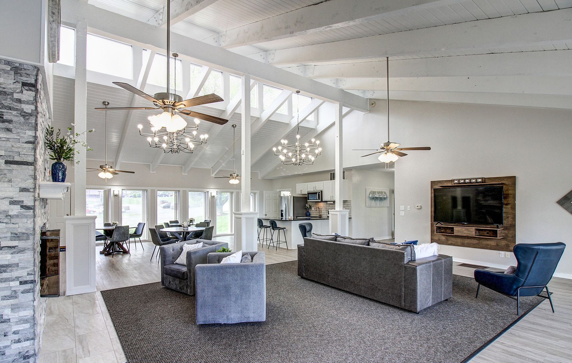 Spacious living room with high ceilings, skylights, and comfortable seating.