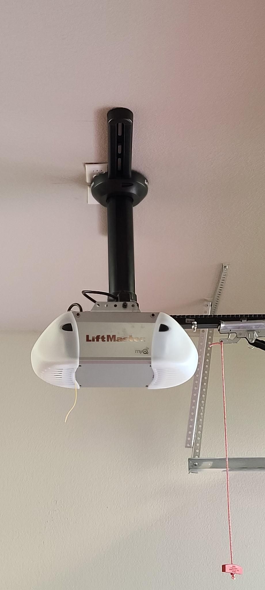 Garage door opener mounted on the ceiling, with lights on either side.