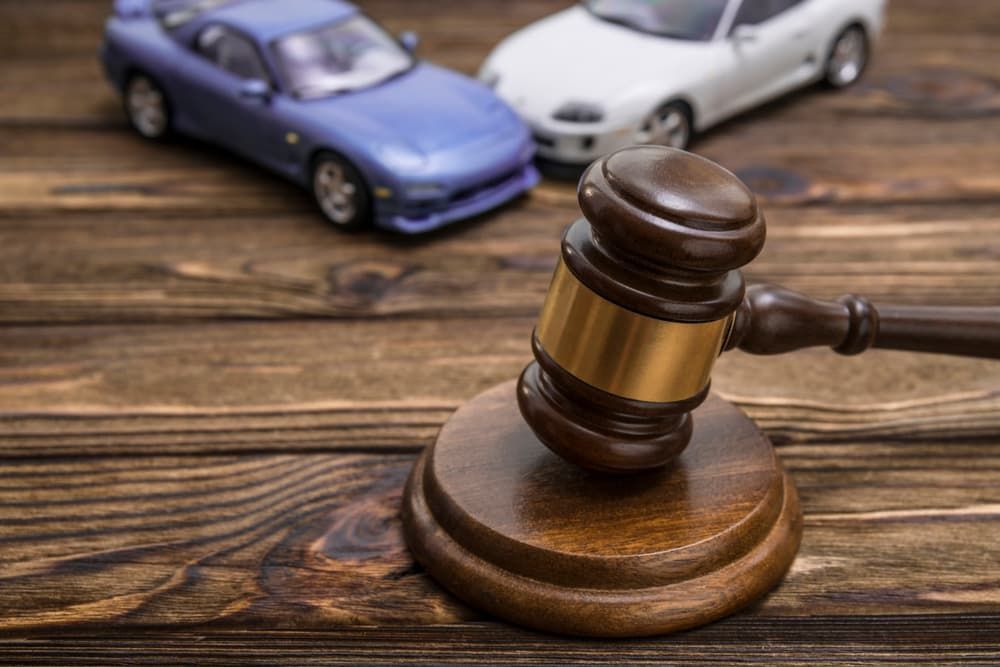 A Gavel And Toy Cars On A Table — Chris Trevor & Associates in Gladstone Central, QLD