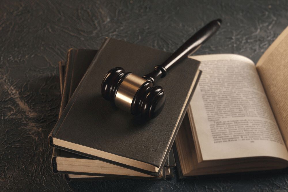 A Judge's Gavel is Sitting on Top of a Stack of Books — Chris Trevor & Associates in Gladstone Central, QLD