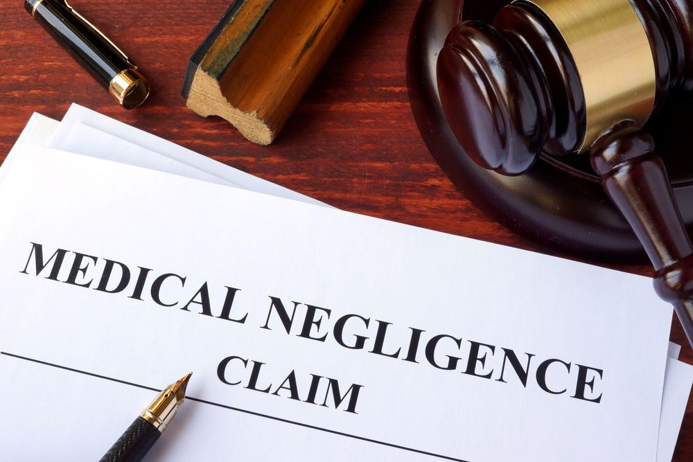 A Piece of Paper That Says Medical Negligence Claim on It — Chris Trevor & Associates in Bundaberg, QLD