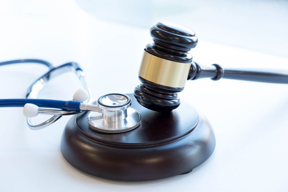 A Judge's Gavel and Stethoscope Are on a Table — Chris Trevor & Associates in Emerald, QLD