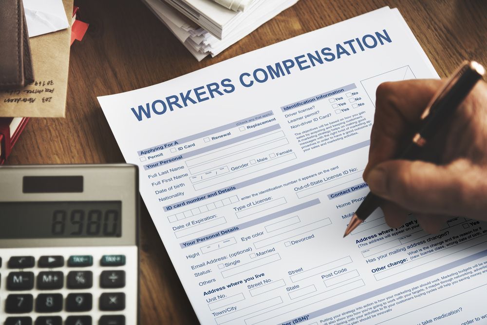 Workers Compensation Form With Calculator And Pen — Chris Trevor & Associates in Gladstone Central, QLD
