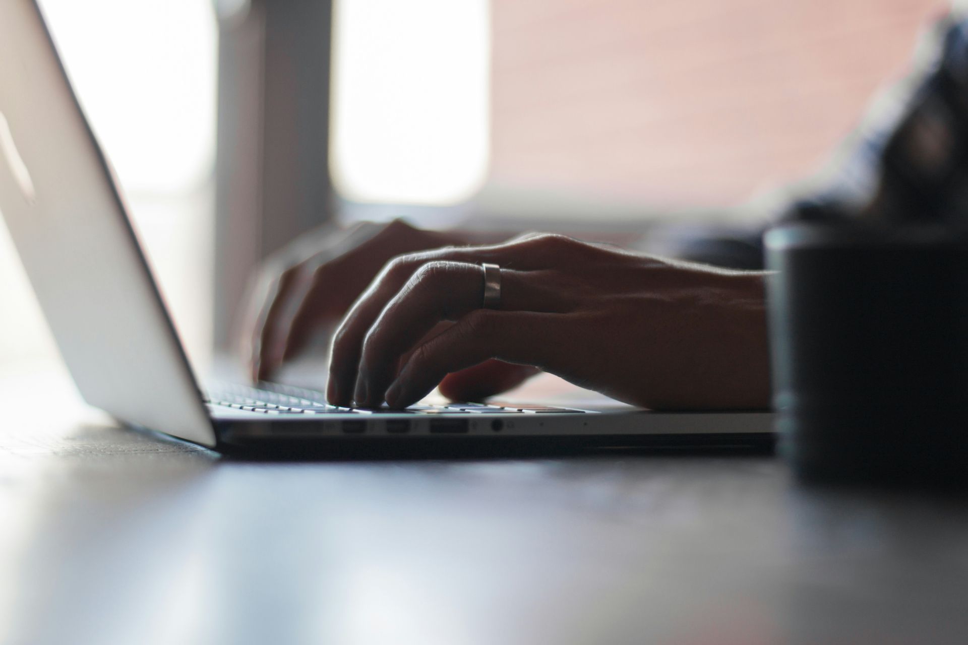 A Person is Typing on a Laptop Computer — Chris Trevor & Associates in Gladstone Central, QLD