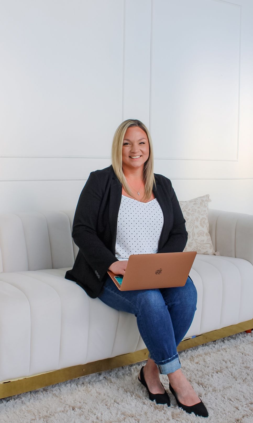A woman in a purple shirt is smiling for the camera.