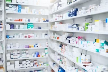 A pharmacy filled with lots of medications on shelves.