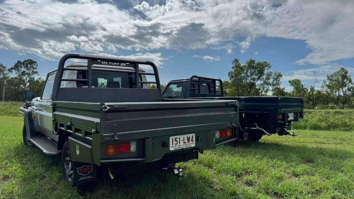 Two Trucks Are Parked Next to Each Other in a Grassy Field — Emerald 4x4 in Emerald, QLD