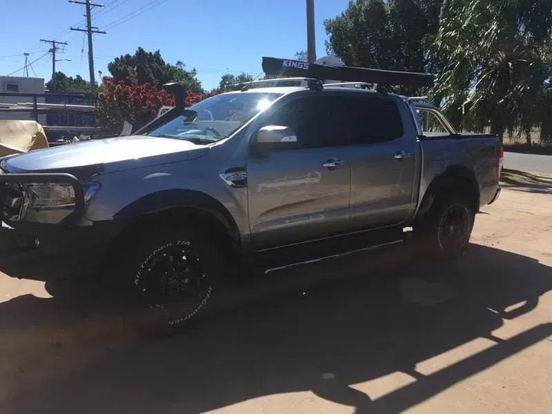 A Silver Truck With a Roof Rack is Parked on the Side of the Road — Emerald 4x4 in Emerald, QLD