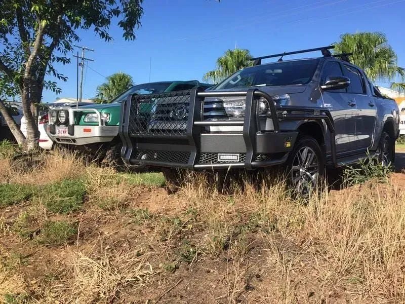 A Row of Trucks Are Parked in a Grassy Field — Emerald 4x4 in Emerald, QLD