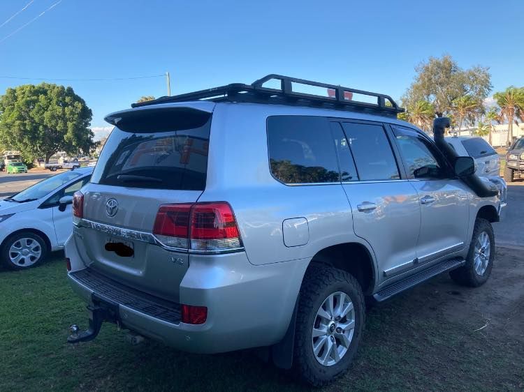A Silver Suv With a Roof Rack is Parked in a Grassy Area — Emerald 4x4 in Emerald, QLD