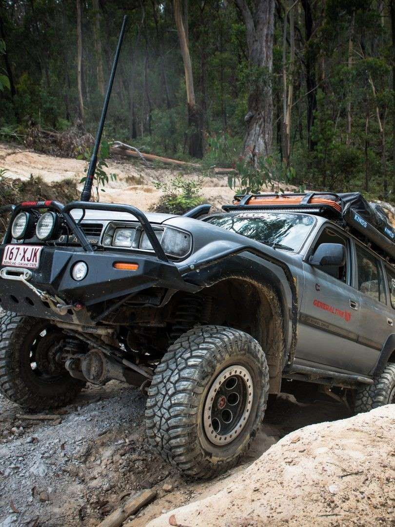 A Jeep is Driving Down a Dirt Road in the Woods — Emerald 4x4 in Emerald, QLD
