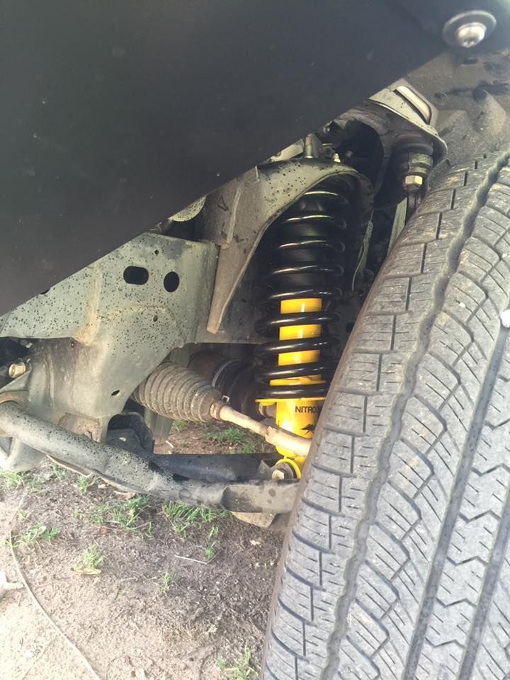 A Close Up of the Underside of a Car With a Shock Absorber and a Tire — Emerald 4x4 in Emerald, QLD